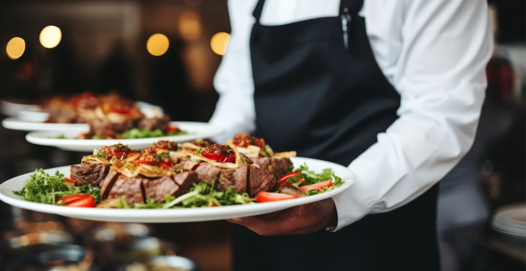 A server carries a tray of meat to a buffet table at a wedding in Northern Virginia