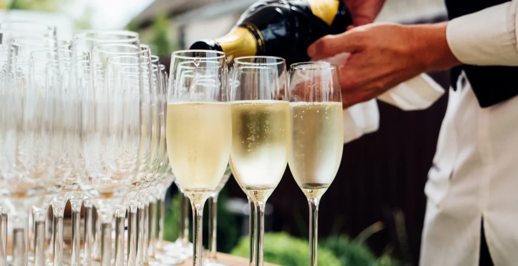 Champagne poured for guests at a wedding celebration