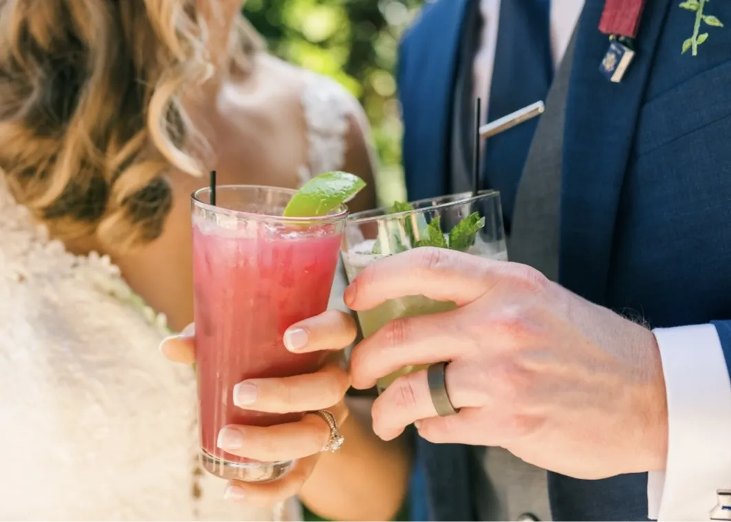 A couple enjoys custom cocktails at their wedding reception catered by Everyone Eats