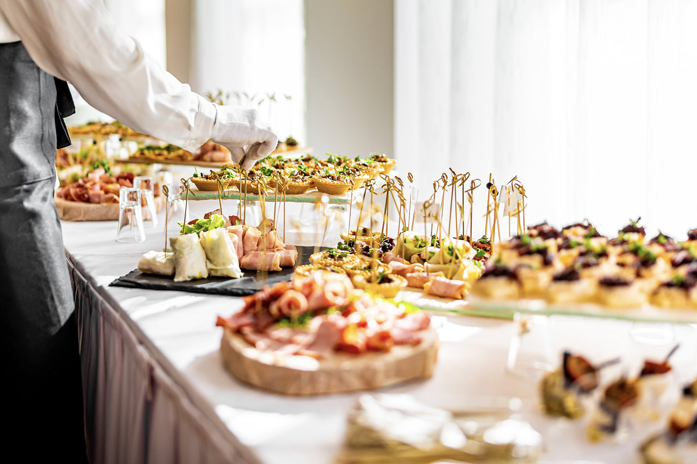 A buffet of canapes and charcuterie boards for a large catered event