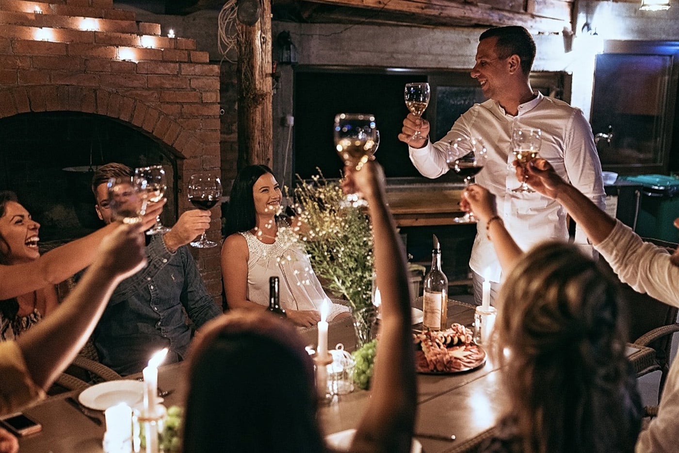 A small group toasts the host at an intimate catered dinner